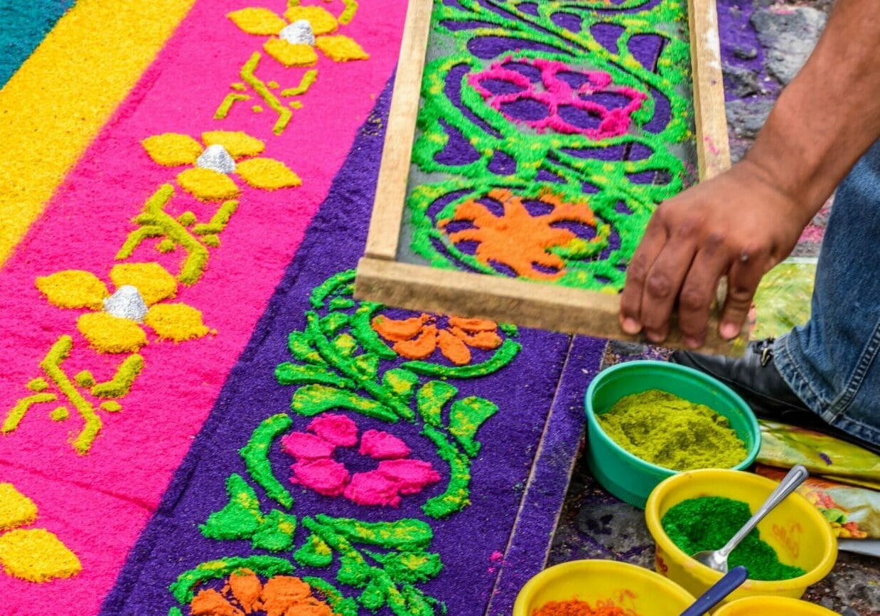 Decorating dyed sawdust Holy Thursday procession carpet in town with most famous Holy Week celebrations in Latin America