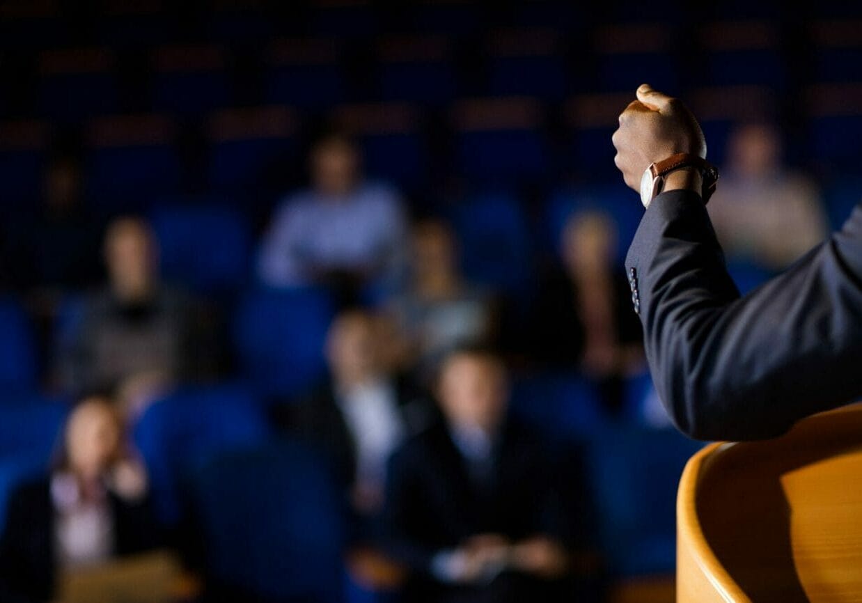 Male business executive giving a speech at conference center